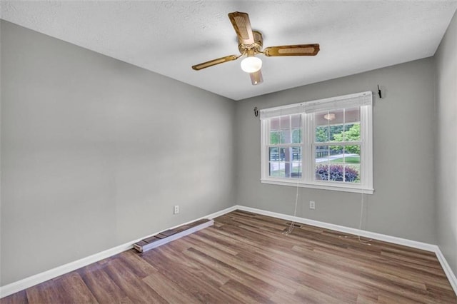 empty room featuring hardwood / wood-style flooring and ceiling fan