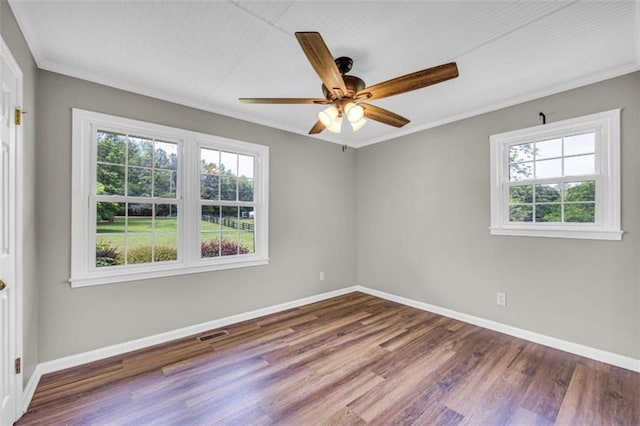 spare room with crown molding, hardwood / wood-style flooring, and ceiling fan