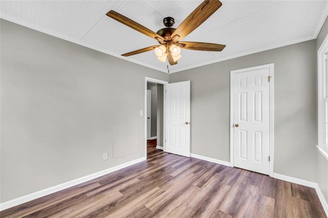 unfurnished bedroom with crown molding, hardwood / wood-style flooring, and ceiling fan