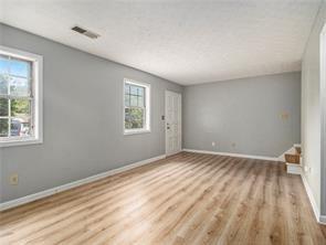 unfurnished room with light wood-type flooring