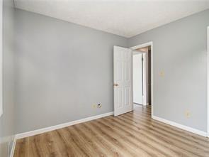 empty room with light hardwood / wood-style flooring