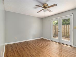 unfurnished room featuring ceiling fan, french doors, and hardwood / wood-style floors