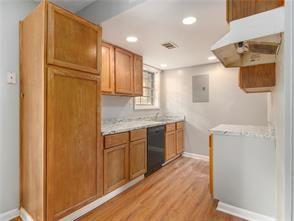 kitchen with dishwasher and light wood-type flooring