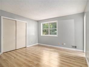 unfurnished bedroom with light hardwood / wood-style flooring and a closet