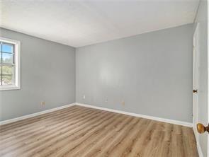 spare room with light hardwood / wood-style floors