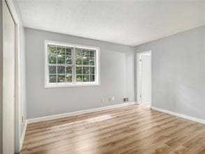 unfurnished room with light hardwood / wood-style flooring