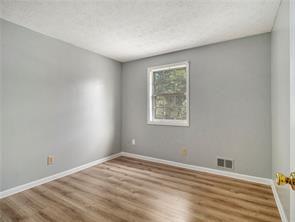 spare room with hardwood / wood-style flooring