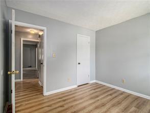 unfurnished bedroom with hardwood / wood-style flooring