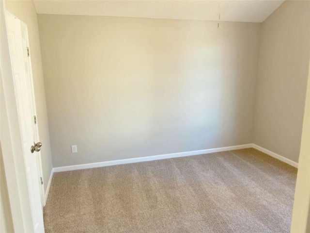 unfurnished room featuring baseboards and carpet flooring