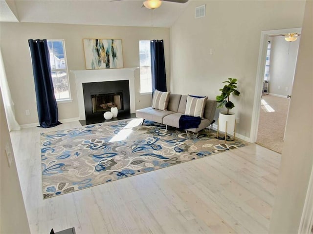 living area featuring a healthy amount of sunlight, visible vents, and a ceiling fan