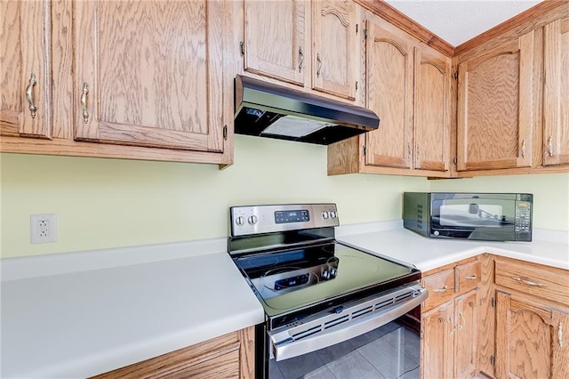 kitchen with black microwave, under cabinet range hood, light countertops, stainless steel electric range, and tile patterned floors