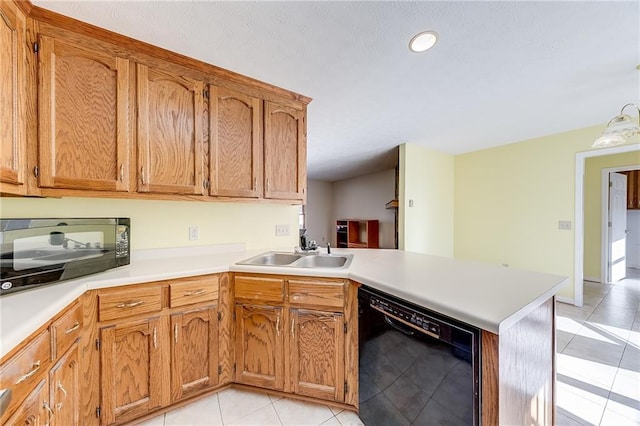 kitchen featuring light tile patterned floors, light countertops, a sink, a peninsula, and black appliances