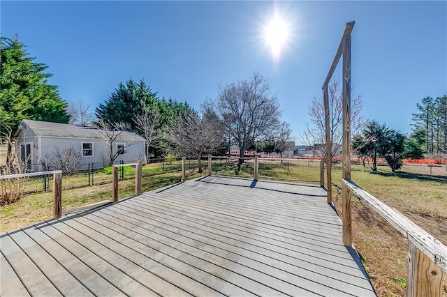 wooden deck featuring a yard and fence