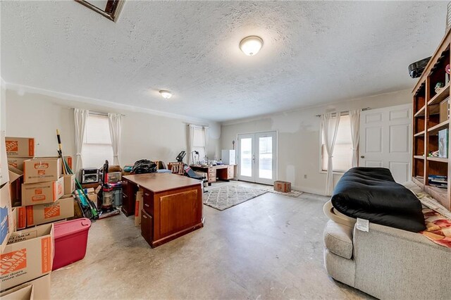 office with concrete flooring, french doors, and a textured ceiling