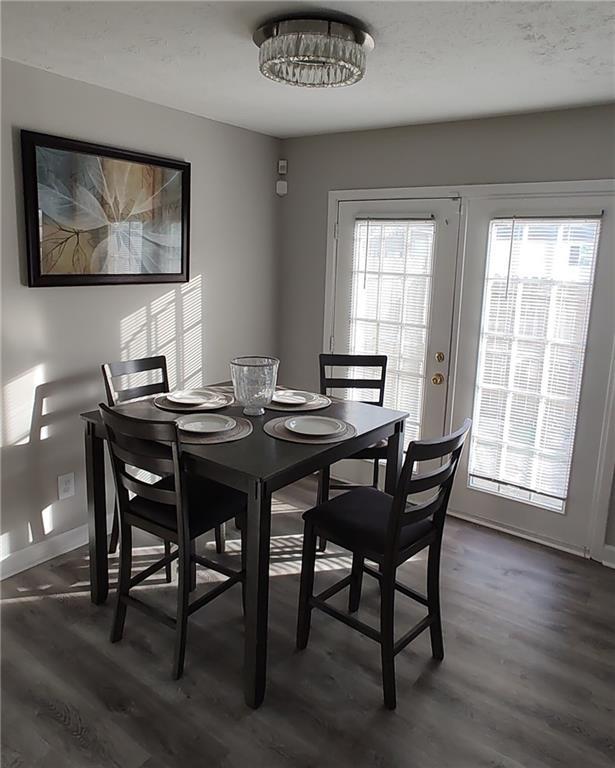 dining area with french doors and dark hardwood / wood-style flooring