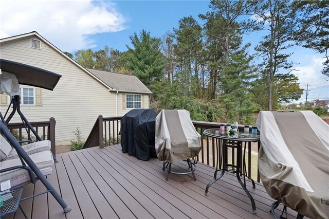 wooden deck with a grill