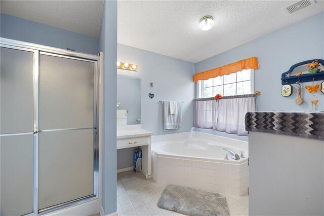 bathroom featuring vanity, tile patterned floors, a textured ceiling, and separate shower and tub