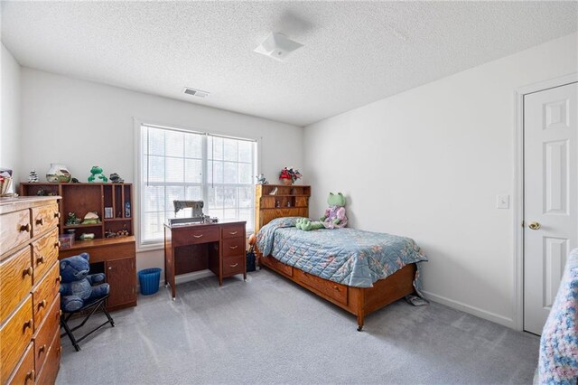 carpeted bedroom with a textured ceiling