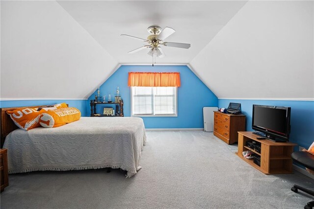 carpeted bedroom featuring vaulted ceiling and ceiling fan