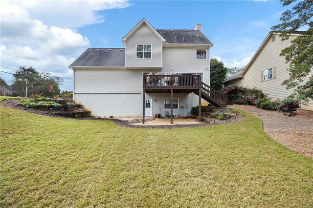 back of property with a lawn and a deck