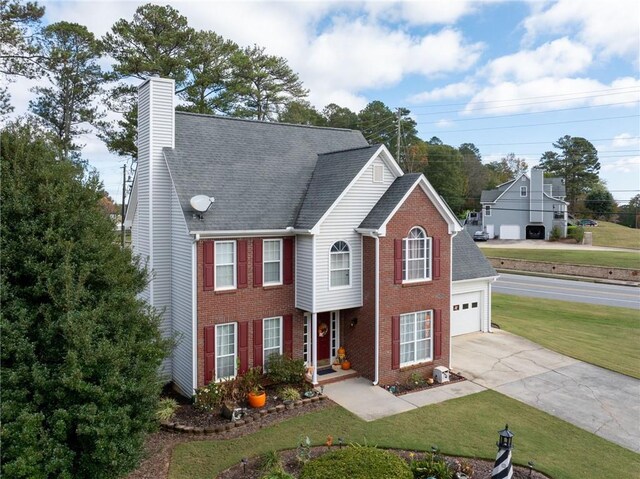 view of front of property with a garage and a front yard