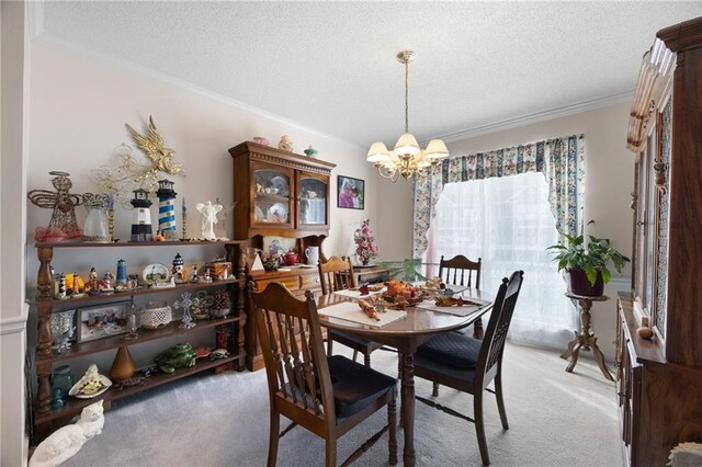 dining space with a chandelier, light carpet, a textured ceiling, and ornamental molding