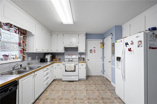 kitchen featuring white cabinets, a barn door, white appliances, and sink