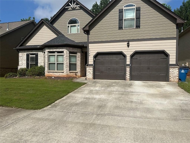 1749 Misselthrush Ln, Mcdonough, GA 30253 - view of front of home featuring an attached garage, a front lawn, driveway, and stone siding