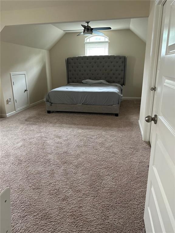 1749 Misselthrush Ln, Mcdonough, GA 30253 - carpeted bedroom with vaulted ceiling, baseboards, and a ceiling fan
