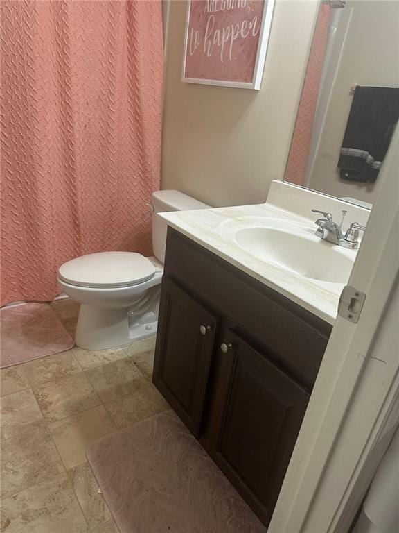 1749 Misselthrush Ln, Mcdonough, GA 30253 - bathroom featuring vanity, toilet, stone finish flooring, and a shower with curtain