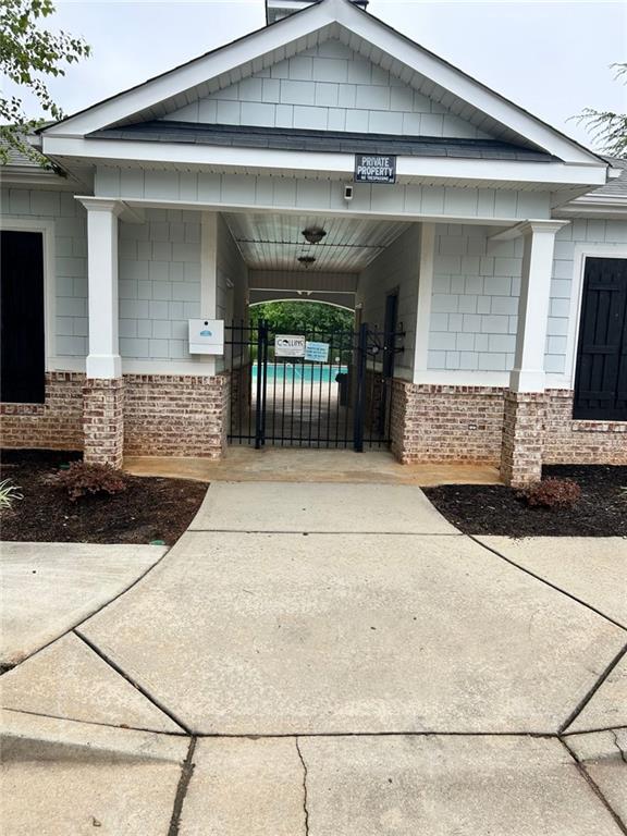 1749 Misselthrush Ln, Mcdonough, GA 30253 - view of community with concrete driveway, a gate, and a carport