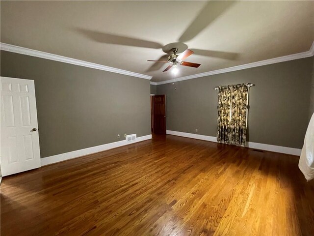 empty room featuring ceiling fan, hardwood / wood-style flooring, and crown molding