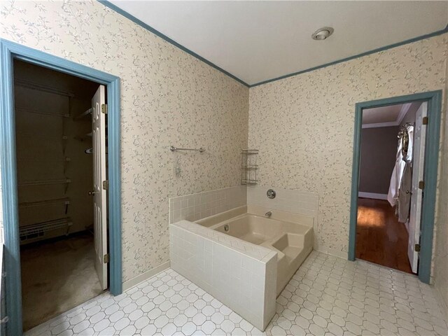 bathroom with ornamental molding and a washtub