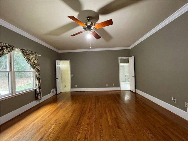 spare room with ceiling fan, ornamental molding, and wood-type flooring