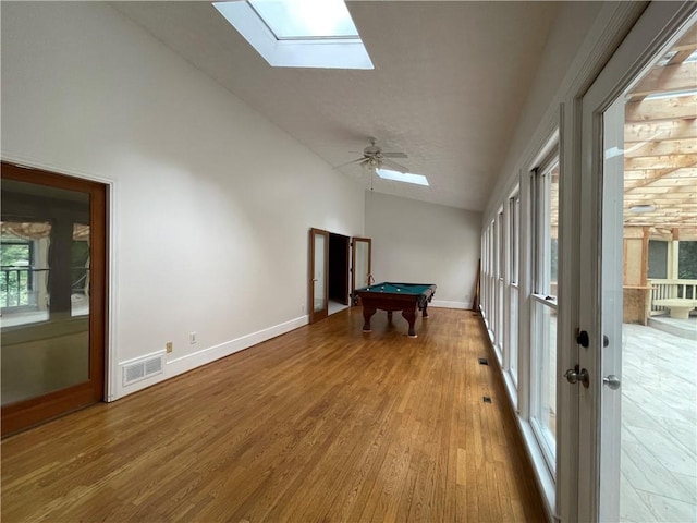 unfurnished sunroom with french doors, vaulted ceiling with skylight, billiards, and ceiling fan