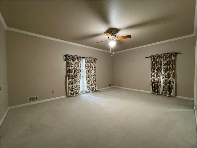 carpeted spare room with ceiling fan and crown molding