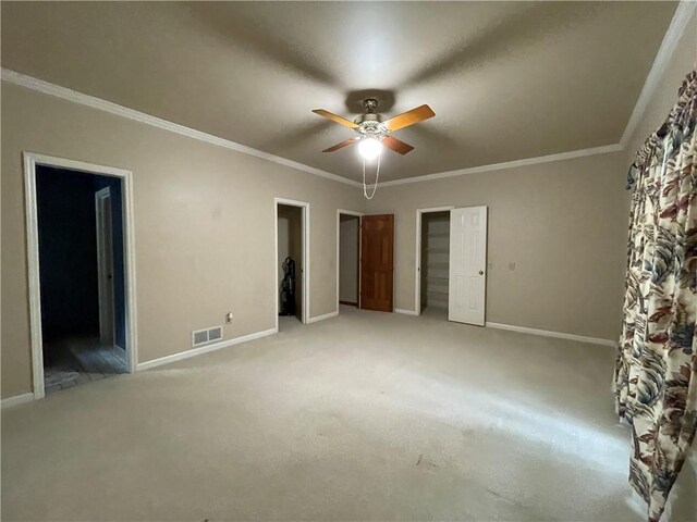 carpeted empty room featuring ceiling fan and ornamental molding