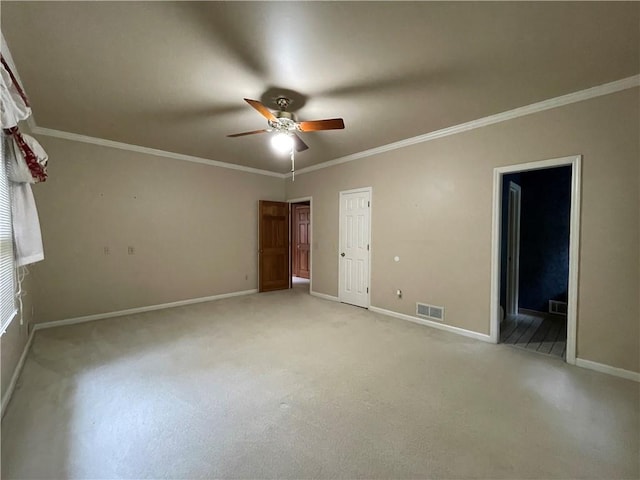 spare room featuring ornamental molding and ceiling fan