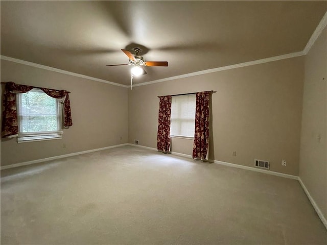 spare room featuring ceiling fan, carpet floors, and a healthy amount of sunlight