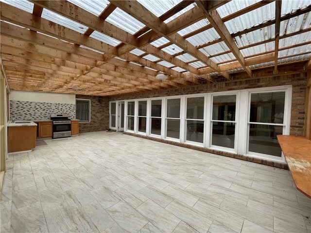 unfurnished living room with brick wall, a skylight, and sink