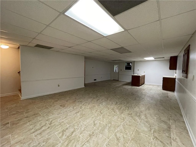 basement featuring a paneled ceiling