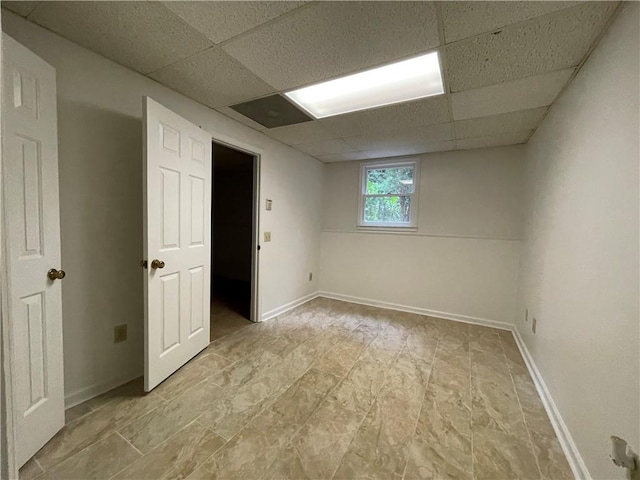 unfurnished room with a drop ceiling