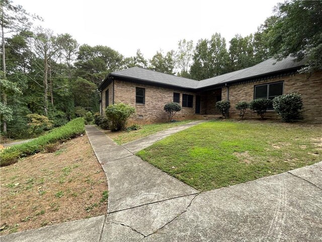 view of side of home featuring a lawn