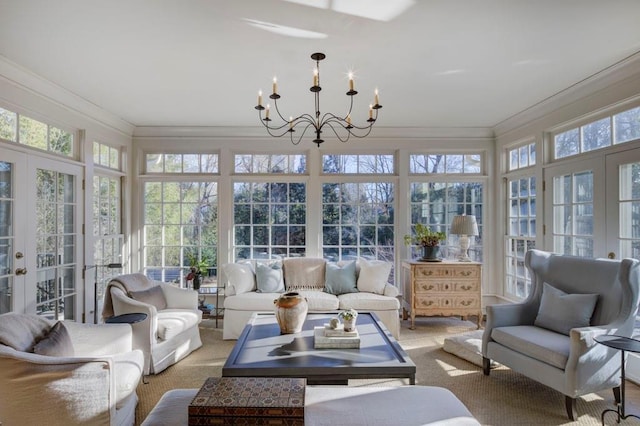 sunroom featuring crown molding, french doors, plenty of natural light, and a notable chandelier