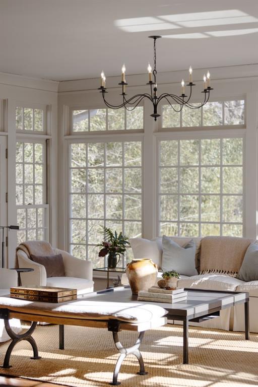 sunroom / solarium with a notable chandelier