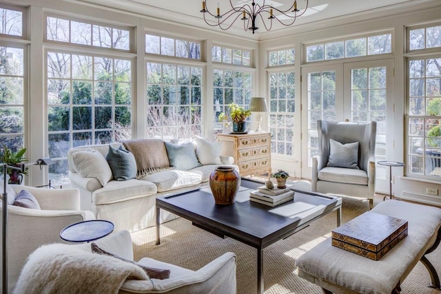 sunroom with a chandelier, crown molding, and plenty of natural light