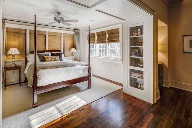 bedroom featuring crown molding, baseboards, ceiling fan, and wood finished floors