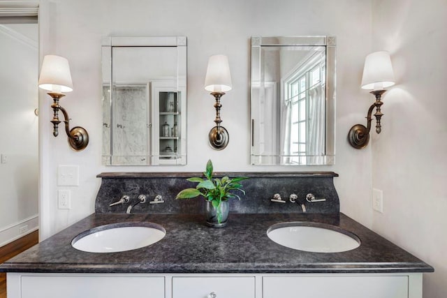 bathroom with a sink and double vanity