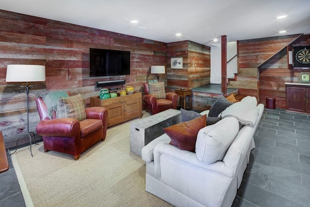 living area featuring wood walls, stairs, and recessed lighting