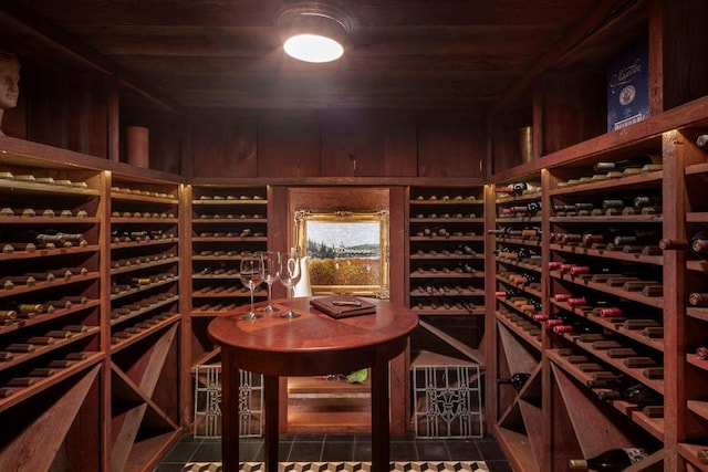 wine area featuring tile patterned floors and wood ceiling